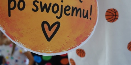Powiększ grafikę: Dziecko w koszulce w piłki trzyma napis: Lubię uczyć się po swojemu!