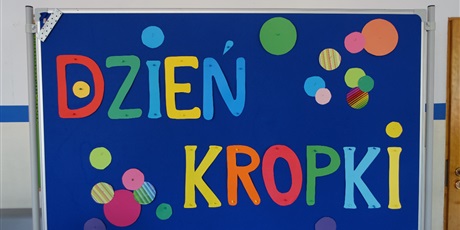 Powiększ grafikę: Tablica z kolorowymi kropkami i napisem: Dzień Kropki