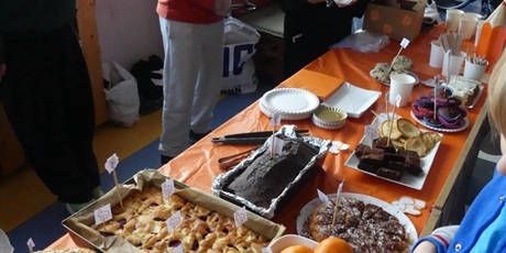 Powiększ grafikę: Stoisko ze słodkościami - widać galaretki, ciasta, mandarynki.